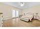 Bright bedroom featuring hardwood floors and a ceiling fan at 5907 Haskell Circle, Myrtle Beach, SC 29572