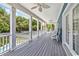 Long deck with white columns and ceiling fan, offering shade and views at 5907 Haskell Circle, Myrtle Beach, SC 29572