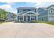 Two-story blue house with white trim, porch, and driveway at 5907 Haskell Circle, Myrtle Beach, SC 29572