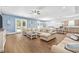 Spacious living room with L-shaped sofa and hardwood floors at 5907 Haskell Circle, Myrtle Beach, SC 29572