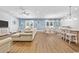 Open concept living area with hardwood floors and a large sectional sofa at 5907 Haskell Circle, Myrtle Beach, SC 29572