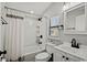 Clean bathroom with shower/tub combo, white vanity, and window at 6001-1235 S Kings Highway, Myrtle Beach, SC 29575
