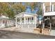 Charming white cottage with a red star and porch at 6001-1235 S Kings Highway, Myrtle Beach, SC 29575