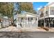 White cottage with a front porch, and nicely landscaped yard at 6001-1235 S Kings Highway, Myrtle Beach, SC 29575
