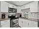 Updated kitchen with stainless steel appliances and white cabinets at 6001-1235 S Kings Highway, Myrtle Beach, SC 29575