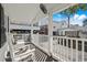 Covered porch with rocking chairs, offering views of surrounding houses at 6001-1235 S Kings Highway, Myrtle Beach, SC 29575