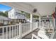 Relaxing front porch with rocking chairs, overlooking the street and neighboring homes at 6001-1235 S Kings Highway, Myrtle Beach, SC 29575