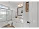 A full bathroom featuring a white vanity with a solid countertop, glass-enclosed shower, and white walls at 637 Sparrow Dr., Surfside Beach, SC 29575