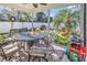 Relaxing covered patio with outdoor dining set, ceiling fan, and views of the landscaped backyard at 637 Sparrow Dr., Surfside Beach, SC 29575