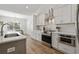 Modern kitchen with white cabinets, stainless steel appliances, and expansive island at 735 Tyson Dr., Pawleys Island, SC 29585