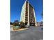 Ocean Dunes Tower II condo building, featuring a multi-story structure with balconies and ample parking at 7500 N Ocean Blvd. # 6145, Myrtle Beach, SC 29572