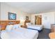 Condo bedroom with two beds, dresser and partial kitchen view at 9550 Shore Dr. # 722, Myrtle Beach, SC 29572