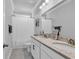 Bathroom featuring double vanity with white cabinets and marble countertops, plus a shower/tub with a white shower curtain at 980 Desert Wheatgrass Dr., Myrtle Beach, SC 29579