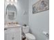 Charming powder room features a vanity, toilet, decorative seahorse, and starfish art for a coastal feel at 980 Desert Wheatgrass Dr., Myrtle Beach, SC 29579