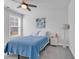 Cozy bedroom featuring a twin bed, a ceiling fan, and a large window offering plenty of natural light at 980 Desert Wheatgrass Dr., Myrtle Beach, SC 29579