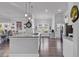 Spacious kitchen with stainless steel appliances, white cabinets, and a large central island at 980 Desert Wheatgrass Dr., Myrtle Beach, SC 29579