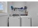 Laundry room with a front loading washer and dryer and upper storage shelf for supplies at 980 Desert Wheatgrass Dr., Myrtle Beach, SC 29579