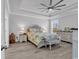 The main bedroom with tray ceilings features a large bed, a ceiling fan, and matching nightstands on wood floors at 980 Desert Wheatgrass Dr., Myrtle Beach, SC 29579