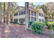 Exterior of a 2-story home with dual screened-in porches, surrounded by trees at 14 Stillwood Dr. # 2, Pawleys Island, SC 29585