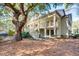 Charming home featuring a double porch and exterior stairway, shaded by a mature tree at 14 Stillwood Dr. # 2, Pawleys Island, SC 29585