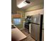 A compact kitchen featuring stainless steel appliances and a bright window at 14 Stillwood Dr. # 2, Pawleys Island, SC 29585