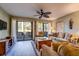 Cozy living room featuring a ceiling fan, golf decor, and a screened-in porch at 14 Stillwood Dr. # 2, Pawleys Island, SC 29585