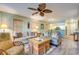 Comfortable living room with a ceiling fan and open view of the kitchen area at 14 Stillwood Dr. # 2, Pawleys Island, SC 29585