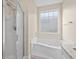 Bathroom with soaking tub, shower, and window at 143 Crane Dr. # A, Pawleys Island, SC 29585