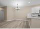 Dining area with chandelier and hardwood floors at 143 Crane Dr. # A, Pawleys Island, SC 29585