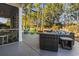 Spacious back patio with wicker furniture and screened porch at 144 Shenandoah Dr., Murrells Inlet, SC 29576