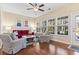Sunroom with red couch and access to backyard at 144 Shenandoah Dr., Murrells Inlet, SC 29576