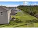 Spacious backyard with covered patio, lush lawn, and a wooded backdrop at 161 Saddle St, Conway, SC 29527