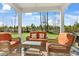 Relaxing covered patio with wicker furniture and orange cushions at 161 Saddle St, Conway, SC 29527