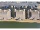 This aerial image displays condo buildings next to water and an expansive parking lot at 1900 Duffy St. # C-7, North Myrtle Beach, SC 29582