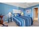 Comfortable bedroom with blue walls, ceiling fan, and stylish decor creates a cozy ambiance at 1900 Duffy St. # C-7, North Myrtle Beach, SC 29582