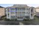 Three story building with palm trees and black shutters at 1900 Duffy St. # C-7, North Myrtle Beach, SC 29582