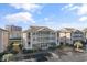 Charming condo building with multiple balconies and manicured landscaping under a blue sky at 1900 Duffy St. # C-7, North Myrtle Beach, SC 29582