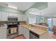 Bright kitchen with a backsplash, stainless steel appliances, and bar seating at 1900 Duffy St. # C-7, North Myrtle Beach, SC 29582