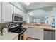 Bright kitchen features white cabinets, stainless steel appliances, and mosaic tile backsplash at 1900 Duffy St. # C-7, North Myrtle Beach, SC 29582