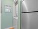 Laundry closet with stacked washer and dryer and stainless steel refrigerator at 1900 Duffy St. # C-7, North Myrtle Beach, SC 29582
