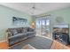 Cozy living room with sliding glass doors leading to a balcony at 1900 Duffy St. # C-7, North Myrtle Beach, SC 29582