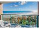 Balcony with a serene view of the ocean, lush greenery, lounge chairs, and sunlit beach at 201 74Th Ave. N # 2640, Myrtle Beach, SC 29572