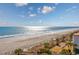 Beautiful oceanfront view featuring sandy beaches, palm trees, sunlit waters and complex buildings at 201 74Th Ave. N # 2640, Myrtle Beach, SC 29572