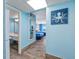 Hallway view leading to bedrooms, features an octopus wall art piece, wood flooring, and adjacent bathroom at 201 74Th Ave. N # 2640, Myrtle Beach, SC 29572