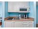 Close-up of the kitchenette featuring a microwave, coffee maker, sink, and ample cabinet space at 201 74Th Ave. N # 2640, Myrtle Beach, SC 29572