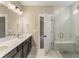 Bathroom with double vanity and glass enclosed shower, featuring marble look shower walls at 217 Wahee Pl., Conway, SC 29527