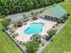 Aerial view of the community pool area with green roof clubhouse surrounded by chairs and landscaping at 217 Wahee Pl., Conway, SC 29527