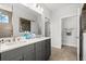 Double vanity bathroom with gray cabinets and a shower at 417 San Benito Ct., Longs, SC 29568