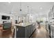 Open concept kitchen with island and stainless steel appliances at 417 San Benito Ct., Longs, SC 29568