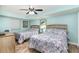 Two twin beds in a well-lit bedroom with light teal walls and ceiling fan at 501 S Ocean Blvd. # 304, North Myrtle Beach, SC 29582
